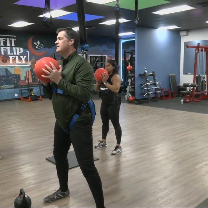 Keith Kaiser uses weights to do bungee exercise